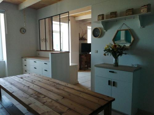 - une cuisine avec une table en bois dans une chambre dans l'établissement ABORD- Vue sur mer, baie de Morlaix, grande maison, école de voile à 100m, à Plougasnou