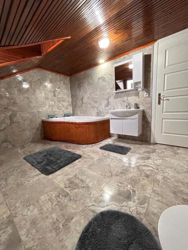 a large bathroom with a tub and a sink at Villa Five Star in Sapanca