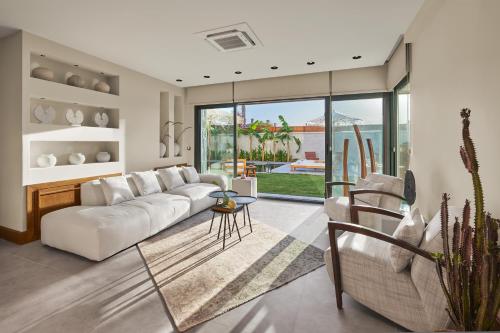 a living room with a white couch and a table at Meruno Alaçatı in Çeşme