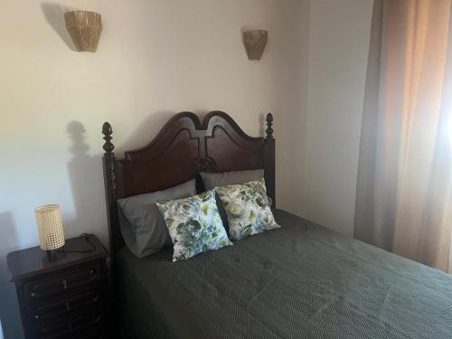 a bedroom with a bed with two pillows on it at Casa dos Sapos in Mértola