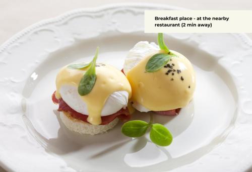 a plate with two deviled eggs on a sandwich at St Casimir Apartments in Vilnius