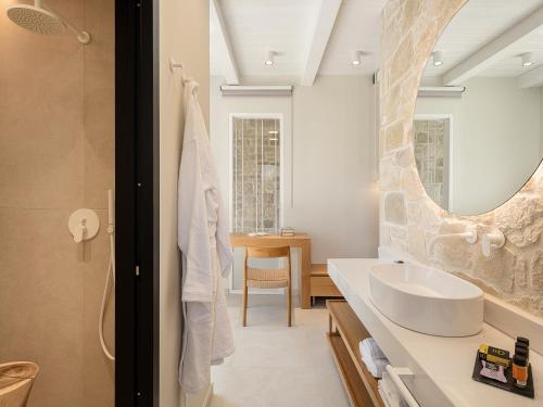 a bathroom with a sink and a mirror at Pietra Di Sabbia Villas in Palaiochora