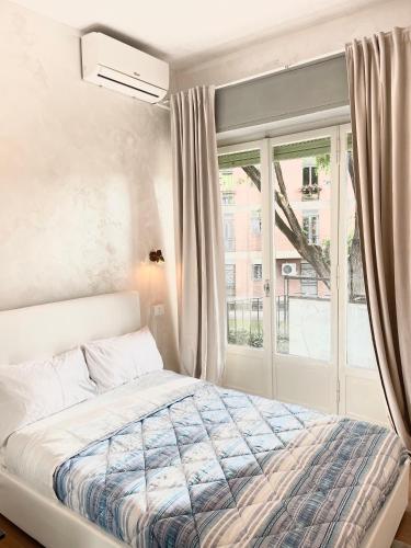 a bedroom with a bed and a window at Romoli Rooms and suites in Rome