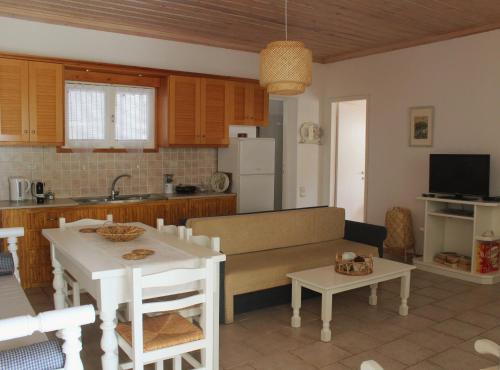 a kitchen and living room with a couch and a table at The Pine Trees in Agnontas