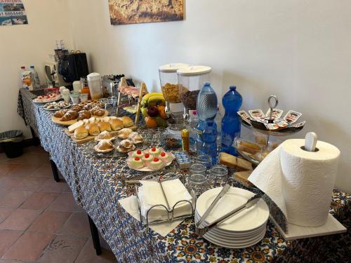 a long table with plates of food on it at B&B IL CONTE in Agrigento