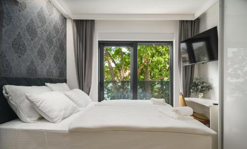 En eller flere senge i et værelse på Villa TRIA QUERCUS