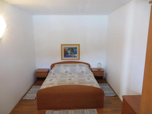 a small bedroom with a bed in a room at Apartments Makjanić in Jelsa