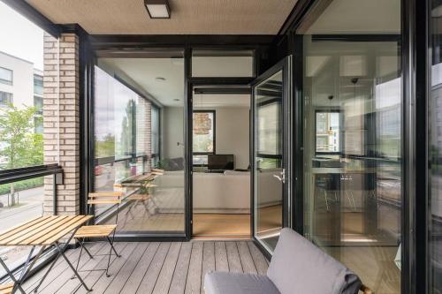 a living room with glass doors and a couch at Hotellitason kodikas 90 m2 huoneisto in Tampere