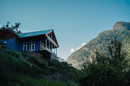 a house on the side of a hill at Soho house in Jibhi