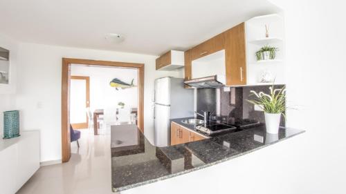 a kitchen with a black counter top in a room at Vista Marina Residence in Boca Chica