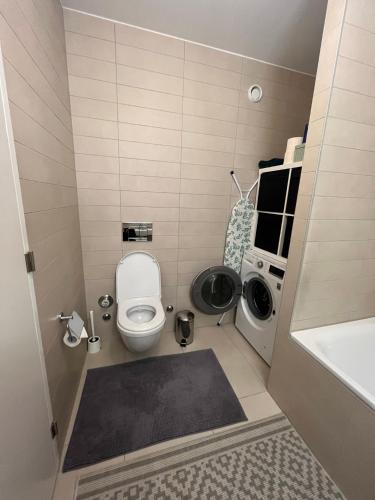 a small bathroom with a toilet and a sink at Studio au centre de Montreux in Montreux