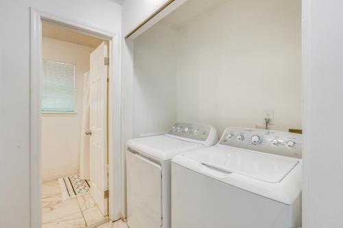a white laundry room with a washer and dryer at Charming Birmingham Home Less Than 6 Mi to Downtown! in Birmingham