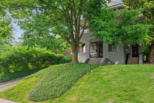 a house with a tree in the front yard at Cincinnati Apartment 1 Mi to Hyde Park Square! in Cincinnati