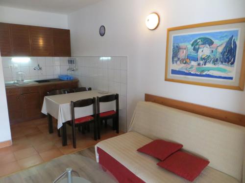a kitchen with a table and a dining room at Apartments Makjanić in Jelsa