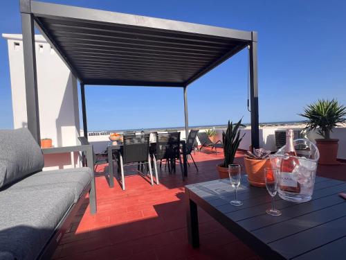 a patio with a table with wine glasses on it at Green Apartment in Tavira Garden in Tavira