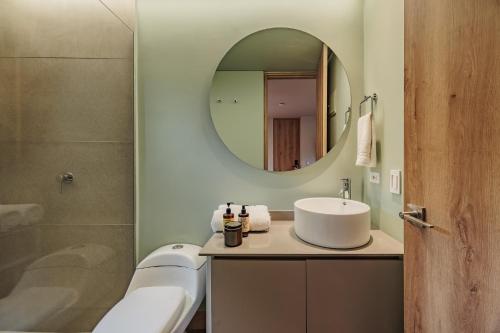 a bathroom with a sink and a mirror at The Somos Central Hotel Poblado in Medellín