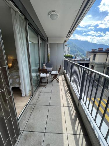a balcony with a table and chairs on a building at Studio au centre de Montreux in Montreux