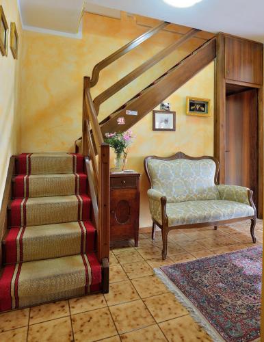 a living room with a staircase and a chair at B&B Villa Lattes in Vicenza