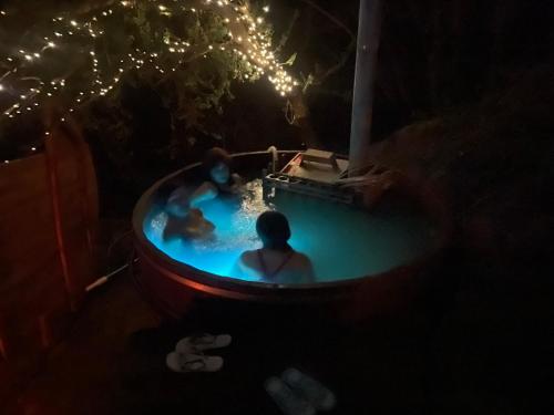 a group of people in a pool at night at Puyacamp, domo de greda in Quillota