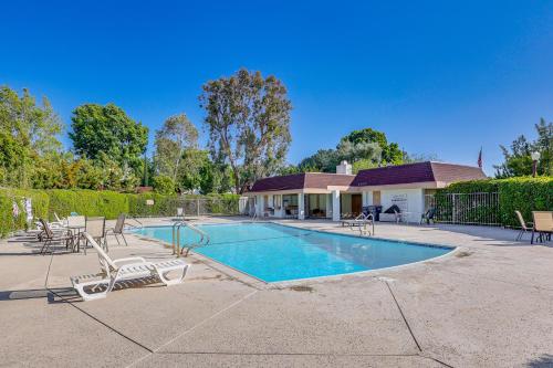 a swimming pool with chairs and a house at Redlands Home with Community Perks 1 Mi to Downtown in Redlands