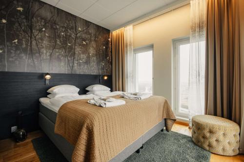a bedroom with a bed and a large window at Best Western Malmo Arena Hotel in Malmö