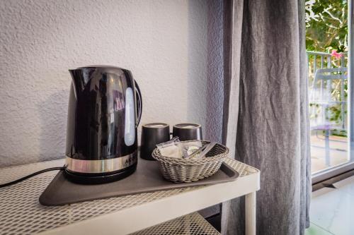 a coffee maker sitting on a table next to a window at Hostal Tropical in Almuñécar