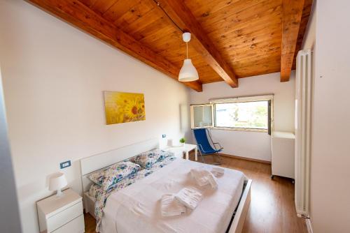 a bedroom with a bed and a wooden ceiling at Appartamenti Adriatico & Gran Sasso in Pineto