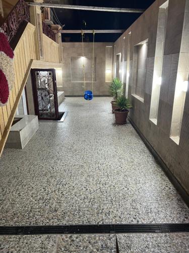 a room with a hallway with stairs and plants at Spacious Master room in newly innovated apt in Dumyāţ al Jadīdah