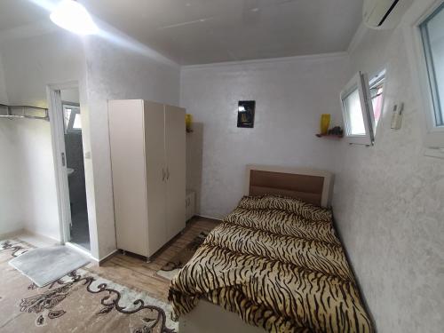 a bedroom with a bed in a white room at Guest house GENO in Batumi