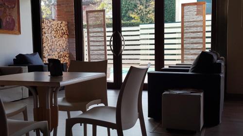 a restaurant with a table and chairs and a piano at Luna Residence Hotel in Casalmaggiore