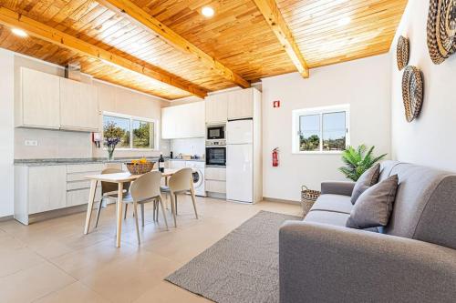 a kitchen and living room with a couch and a table at Salicos House - Lagoa - Benagil in Lagoa