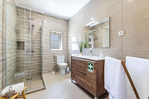 a bathroom with a shower and a sink and a toilet at Salicos House - Lagoa - Benagil in Lagoa