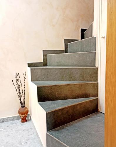 a concrete staircase in a house with a vase at Domus Vivendi in Chania Town