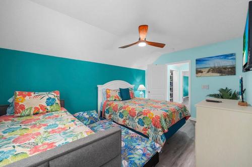 a bedroom with two beds and a ceiling fan at 2 Bedroom Coastal Cottage 1 block to the beach in Myrtle Beach