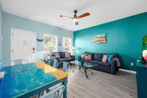 a blue living room with a couch and a table at 2 Bedroom Coastal Cottage 1 block to the beach in Myrtle Beach