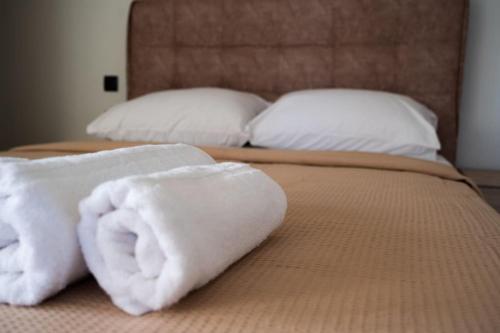 two towels sitting on top of a bed at Villa Arancia in Argos
