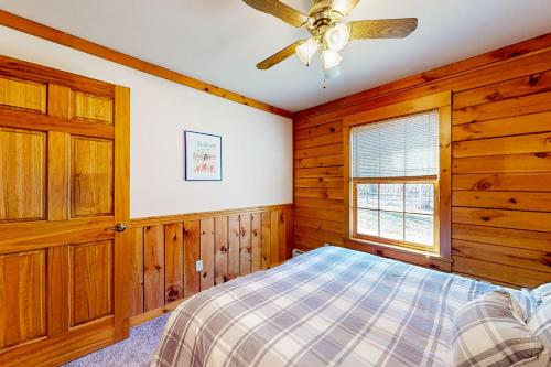 a bedroom with a bed and a ceiling fan at Summit Solitude in Franconia
