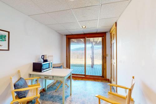 a room with a desk with a computer and a window at Summit Solitude in Franconia