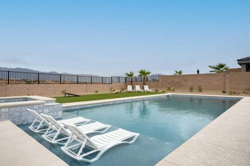 a swimming pool with two lounge chairs and a swimming pool at Mesquite Vacation Home with Spacious Pool in Mesquite