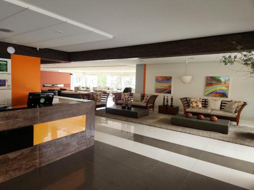 a large living room with couches and a lobby at Apartamentos em Rio Quente com maravilhosa área de lazer e excelente localização in Rio Quente