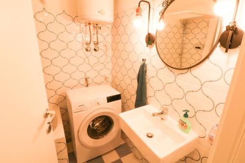 a bathroom with a washing machine and a sink at Apartments by the sea Baska, Krk - 19524 in Baška