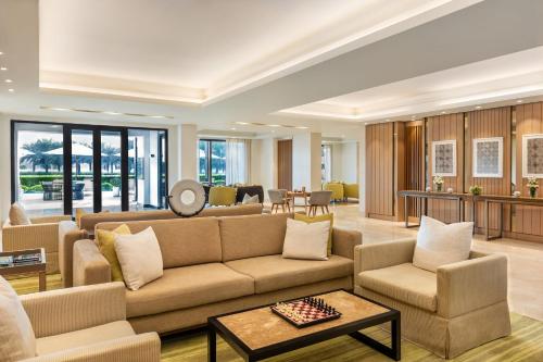 a living room with a couch and chairs at InterContinental Fujairah Resort by IHG in Al Aqah