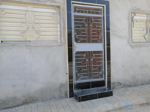 a building with a door on the side of it at Bokidan appartement in Andalouciene