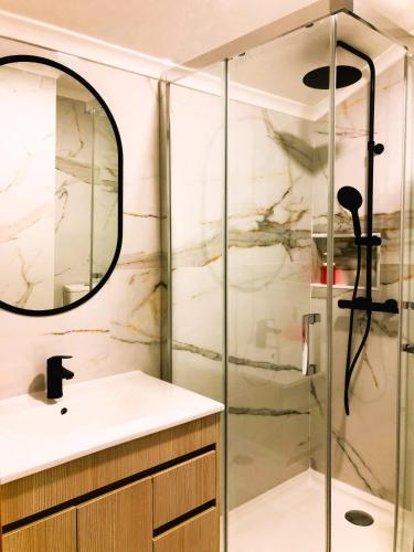 a bathroom with a sink and a shower at Casa das Bicicletas in Peniche