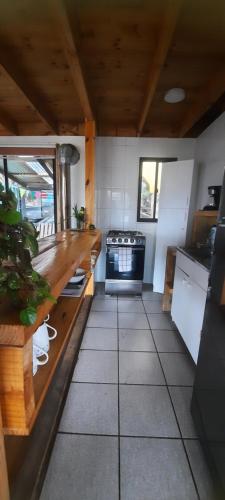 a kitchen with a counter and a stove in it at Palmar Matanzas in Boca Pupuya