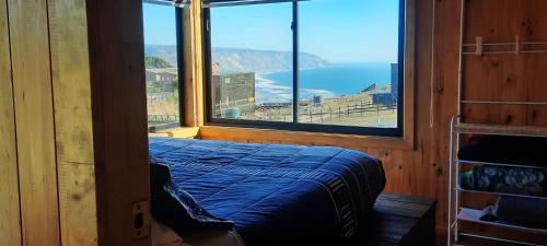 a bedroom with a bed and a large window at Palmar Matanzas in Boca Pupuya