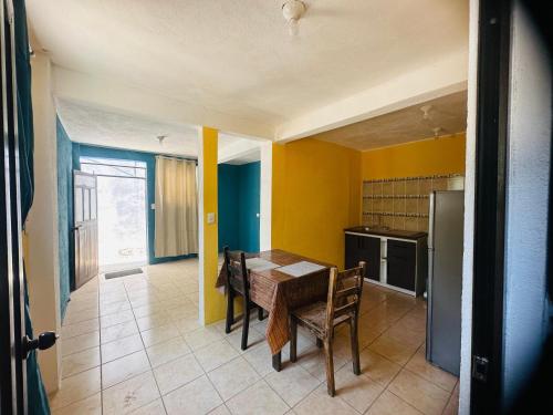 a kitchen with a table and chairs in a room at Casa Mama Wela in San Pedro La Laguna