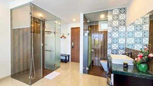a bathroom with a shower and a sink at Riverside White House Hotel in Hoi An
