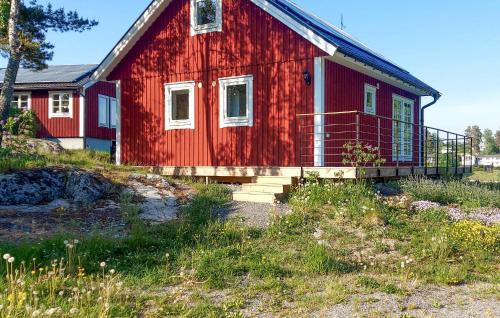 a red house with stairs leading up to it at Nice Home In Åkersberga With Wifi in Åkersberga