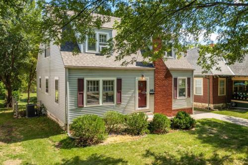 a white house with a red door in a yard at 3 Bed 1 5 Bath Home By College Hill & Hospitals in Wichita